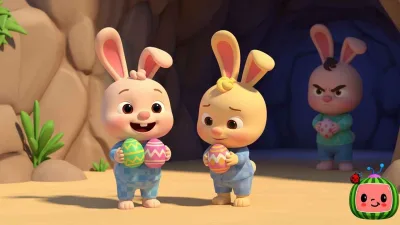 Ilustrasi kartun gaya Cocomelon menampilkan dua kelinci kecil memegang telur Paskah berwarna-warni dengan wajah gembira dan malu, sementara seekor kelinci lain berdiri di dalam gua dengan ekspresi marah.