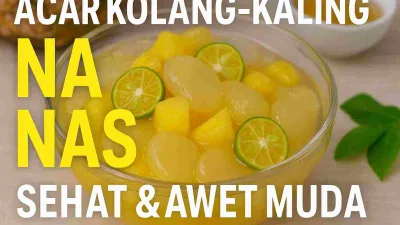 Acar kolang-kaling nanas segar dalam mangkuk kaca dengan potongan jeruk kalamansi dan nanas, menampilkan warna kuning cerah yang menggugah selera.