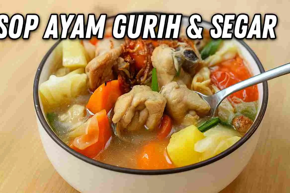 Semangkuk sop ayam rumahan berisi potongan ayam, wortel, kentang, kol, dan tomat dengan kuah bening gurih, diambil dekat dengan sendok yang sedang menyendok potongan ayam.